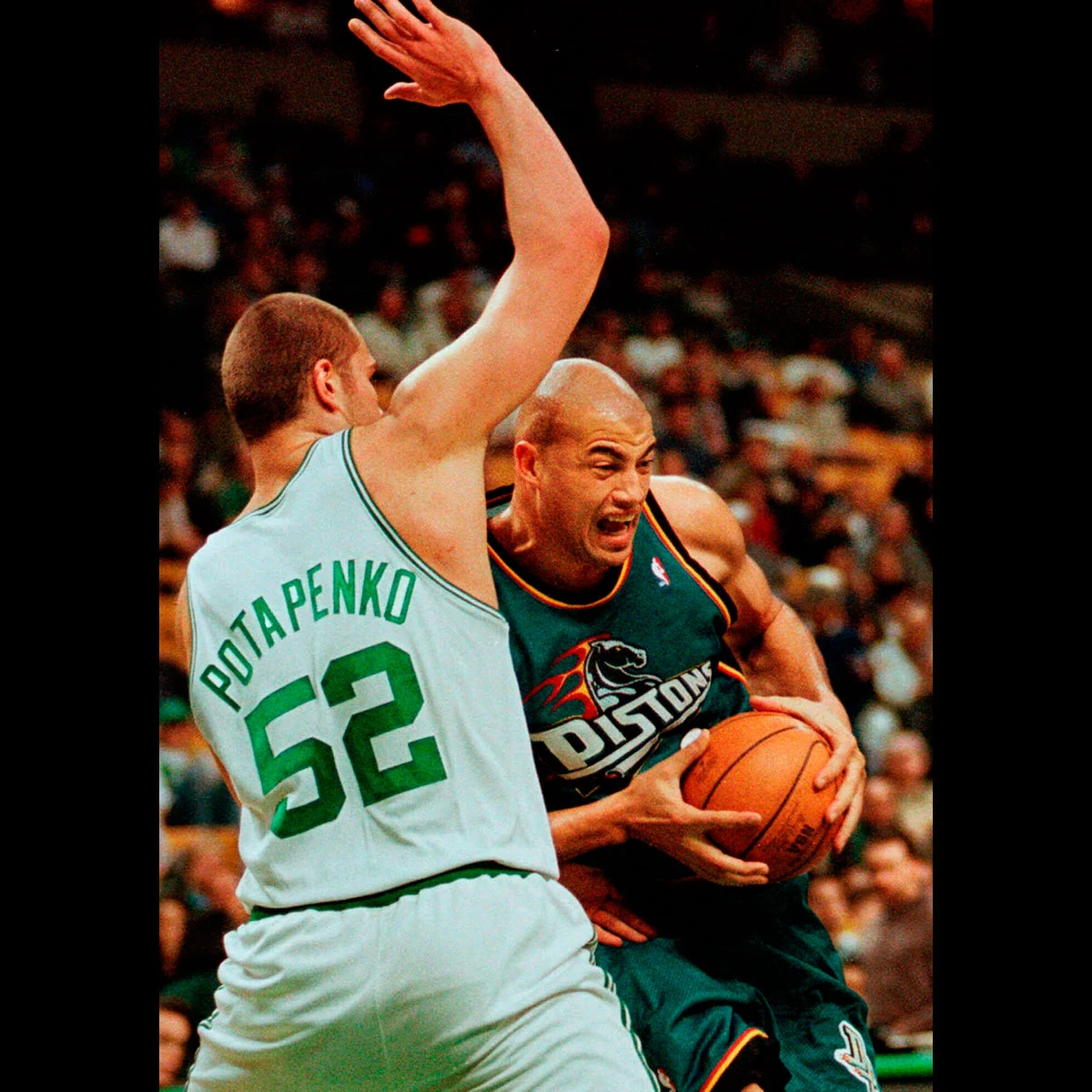 While playing for the Detroit Pistons in 1999, Williams drives past the Boston Celtics' Vitaly Potapenko.