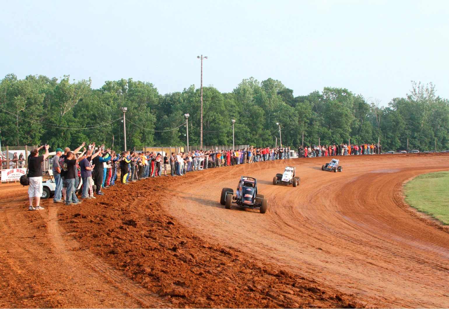 The racing goes on at Bloomington Speedway, where Josh Burton’s memory is kept alive. Here, fans and fellow racers gathered along the backstretch of the track for a procession in his honor last June 7.