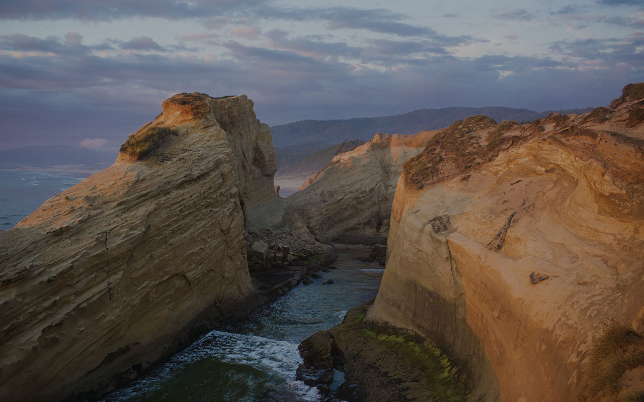 Rocky coastal cliffs and a narrow inlet in Oregon.