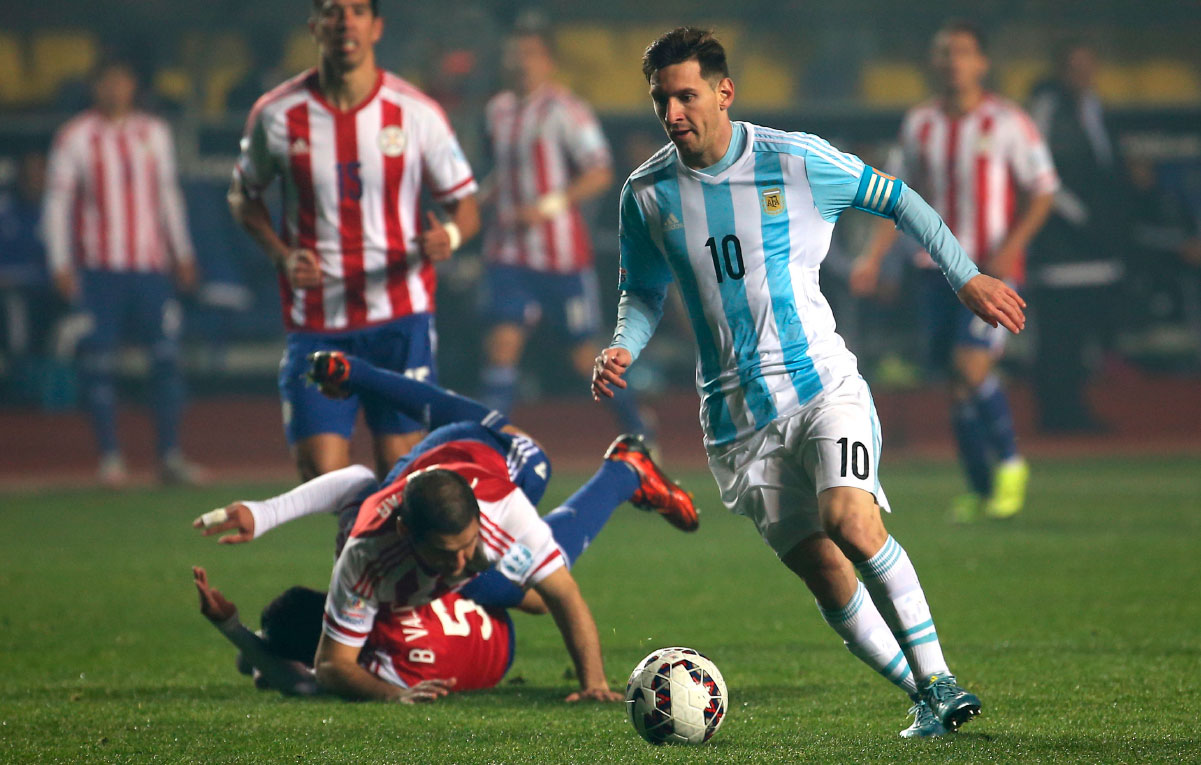 Lionel Messi running with the ball for Argentina during a match.